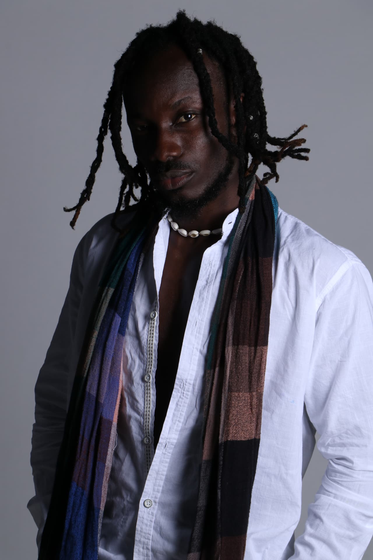Portrait of Trevor Georges wearing a cowrie-shell necklace