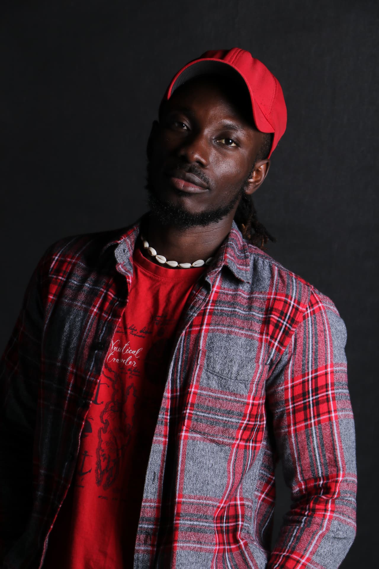 Trevor Georges in a red cap and plaid shirt