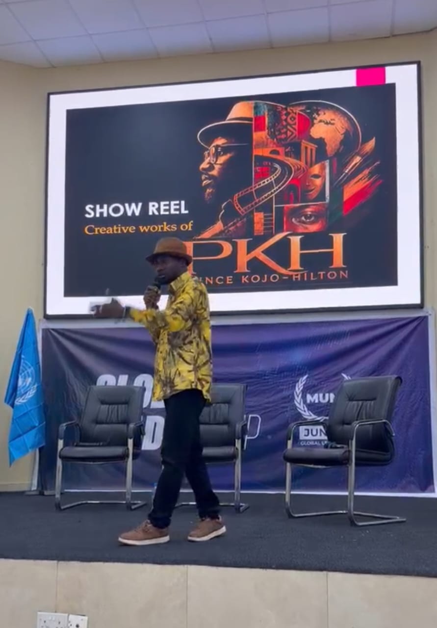 Prince Kojo-Hilton presenting his creative show reel on stage at a global leadership summit