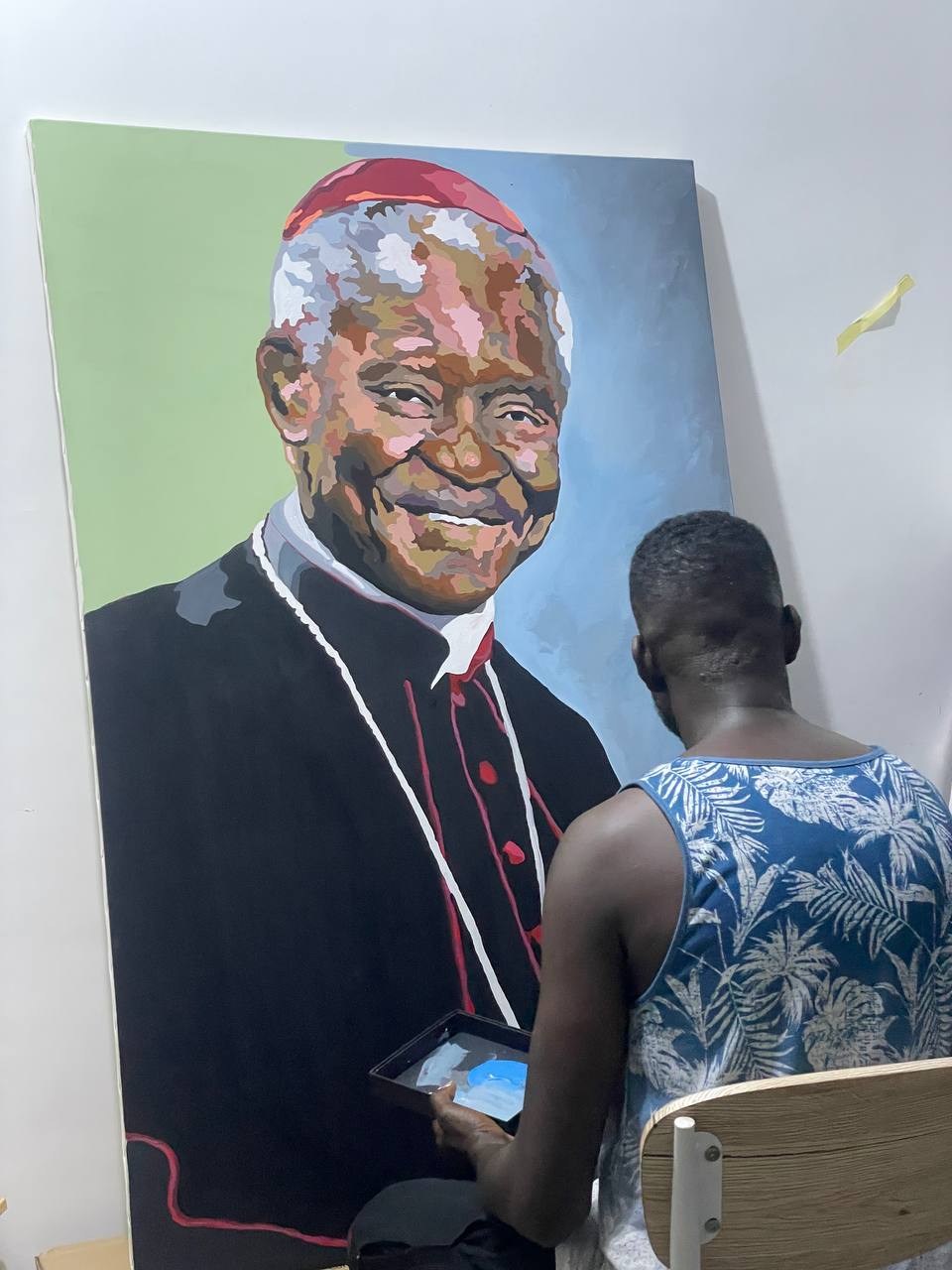 Kizito Nii Amarh Amartey at work on a commissioned portrait painting in his studio